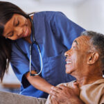 Brazilian senior man, volunteer nurse or support caregiver help with elderly in medical nursing hom.