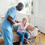 Doctor or nurse caregiver with senior woman using walker assistanece  at home or nursing home