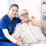 Portrait of female doctor and Elderly patients sitting on couch at home.