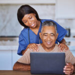 Senior man, laptop and black caregiver or home nurse helping patient with social media, communicati.